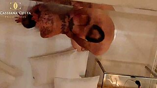 Cassi intriguingly balances big tits while giving handjob and riding