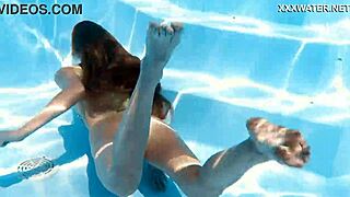 Russian baddy Ivi Rein, blonde and juicy, gets horny underwater in her dress, smoking seductively.