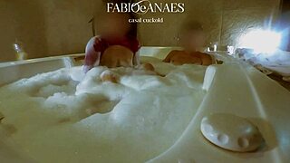 I film my wife enjoying a naughty moment in the jacuzzi with her friend until he cums on her face.