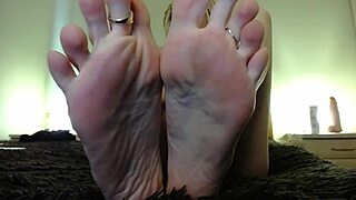 Mesmerizing barefoot feet in femdom domination, where the fetish queen teases with her toes and asserts control over her submissive partner
