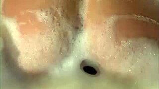 I film my wife enjoying a naughty moment in the jacuzzi with her friend until he cums on her face.