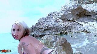 Blonde pornstar Gina Snake strips by the sea with big boobs
