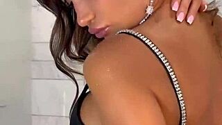 Monika Fox plays with a pink toy in foamy bathroom play