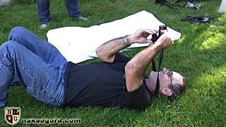 Why is this ballgagged slave dangling in tight bondage submission?