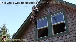 Why is this ballgagged slave dangling in tight bondage submission?