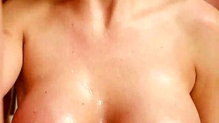 a busty pornstar is sucking a group of cocks in a bukkake scene