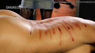 Domina unleashes harsh whipping on her bound redhead slave in intense session