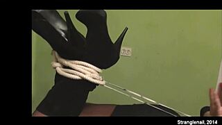 Girl bound tight in hogtie fetish play