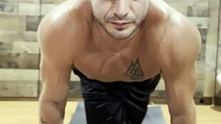 Stretching with Muscular Bodybuilder in Sexy Pose