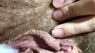 The woman bends over, a dark skinned man penetrates a farm tool