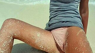 sexy blonde plays with herself by the sea. hot ass in sand?