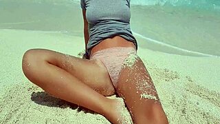 sexy blonde plays with herself by the sea. hot ass in sand?