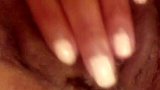 Ebony babe fingers her wet pussy to squirting orgasm