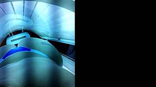 Brazilian slut prepares big ass for lover in tanning booth.