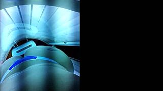 Brazilian slut prepares big ass for lover in tanning booth.