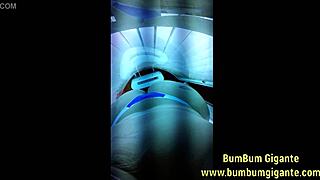 Brazilian slut prepares big ass for lover in tanning booth.