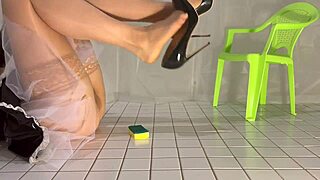 A kinky gay fetish: Cleaning in PVC maid outfit and dangling shoes.