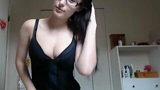 Brunette with glasses moves from thumbler chats to steamy bed action on webcam.