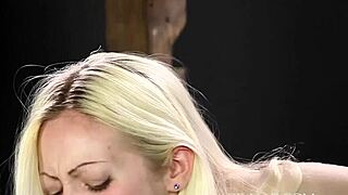 The blonde girl receives caning punishment in a bdsm session at the office, focusing on discipline and control.