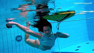 Naked Russian girl swims in the pool and shows her slim body
