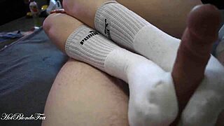 Miley Grey's sexy footjob contrasts with her innocent long socks.