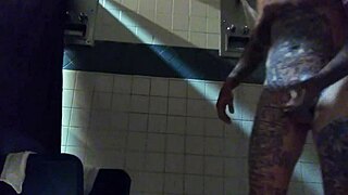 This is a webcam video of a tattooed up white man masturbating in the shower