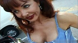 big boobed mature woman sucking deeply on a cock