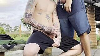 Young guys engage in gay sex outdoors in public square, visible to everyone passing by.