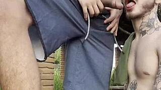 Young guys engage in gay sex outdoors in public square, visible to everyone passing by.