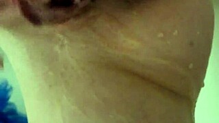 A young woman gets a sensual shower and her friend helps her to reach an orgasm