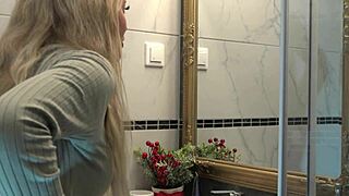 Pretty wife undressing in the bathroom