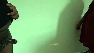 An Indian maid, Sridevi, masturbates a black man’s penis that she has oiled up