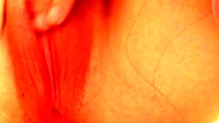 Teasingly spreading juicy pussy lips close-up