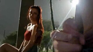 A daring street handjob for a hot redhead at the bus stop