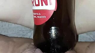 Pregnant Gretala rubs bottle on juicy pussy lips