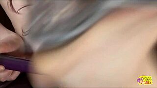 These two lesbian friends are using a sex toy in the living room