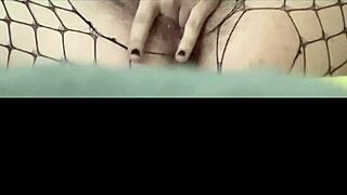 Young 18+ babe fingers herself to orgasm in sexy fishnets