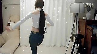 Sexy Chinese girl performs alluring dance on webcam for online viewers.