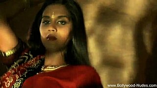 Beautiful brunette Indian dancer seduces with striptease, ripping clothes in teasing softcore scene.