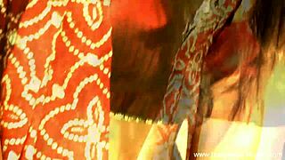 Beautiful brunette Indian dancer seduces with striptease, ripping clothes in teasing softcore scene.