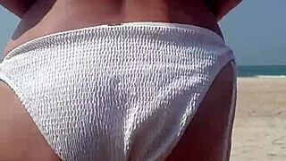 Peeing in White Bikini on Public Beach with Fat Ass