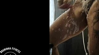 Redhead shaves her wet pussy in the shower!