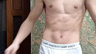 Skinny boy flexes intensely in underwear