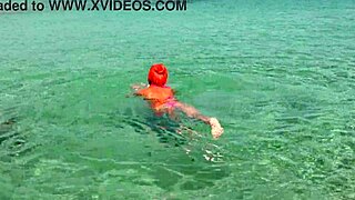 Feeling free in pink bikini at beautiful bay