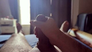 Sun rays hit homemade bedroom while masturbating big monster cock in close up