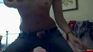 Amateur webcam girl strips clothes, gets wet, and uses dildo toy in ripped outfit.