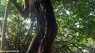 Naked skinny tribe woman crafts bow for outdoor solo hunting adventure