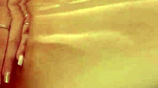 Hot babe caresses herself rubbing pink pussy with pierced nipples in bathtub solo masturbation