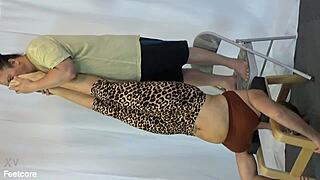 Hiring manager carefully examines life-guard's soft soles during fetish interview