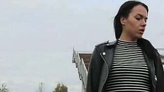 brunette in tight leather leggings with high heels and biker jacket for outdoor fetish style